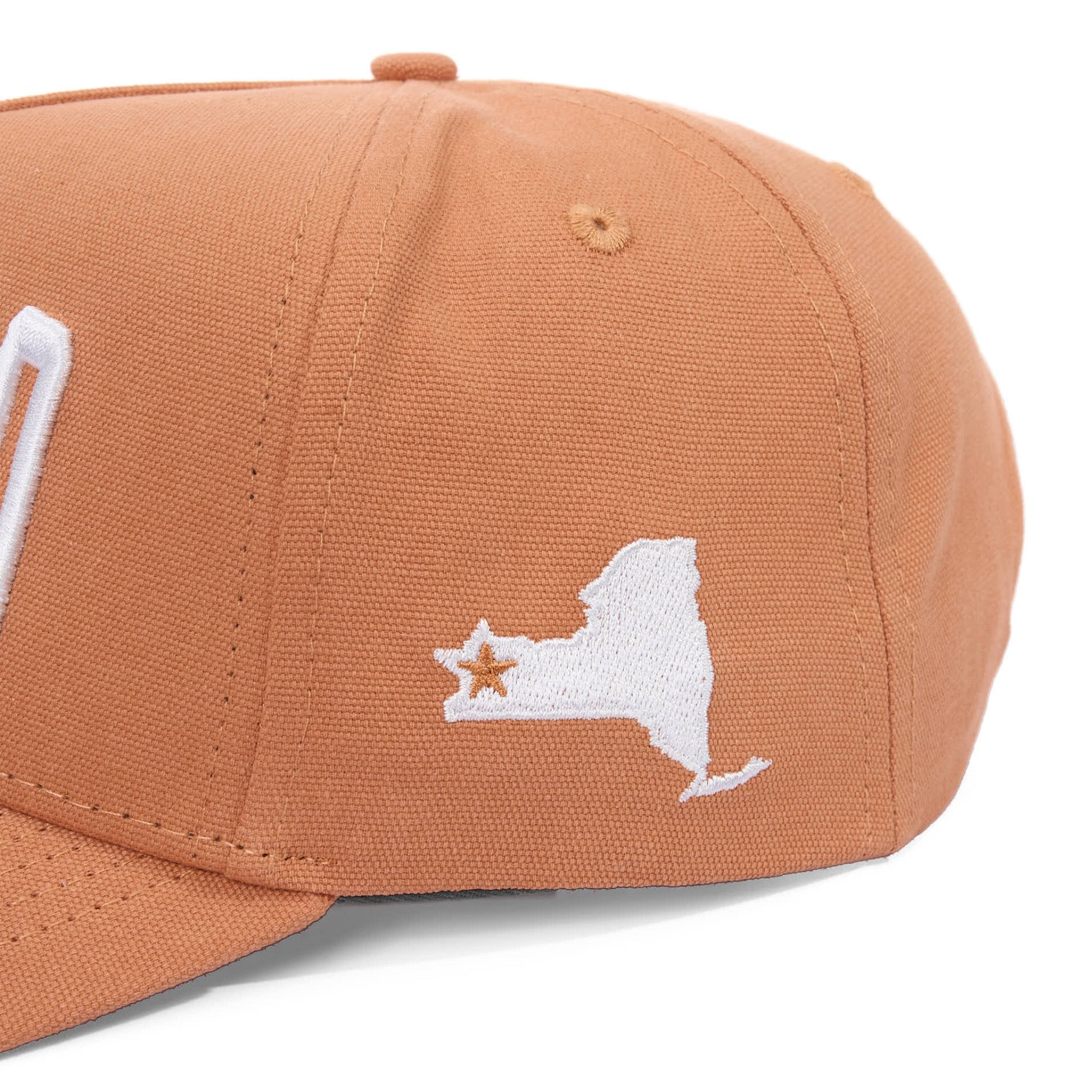 Brown cap with a white embroidered design on a white background