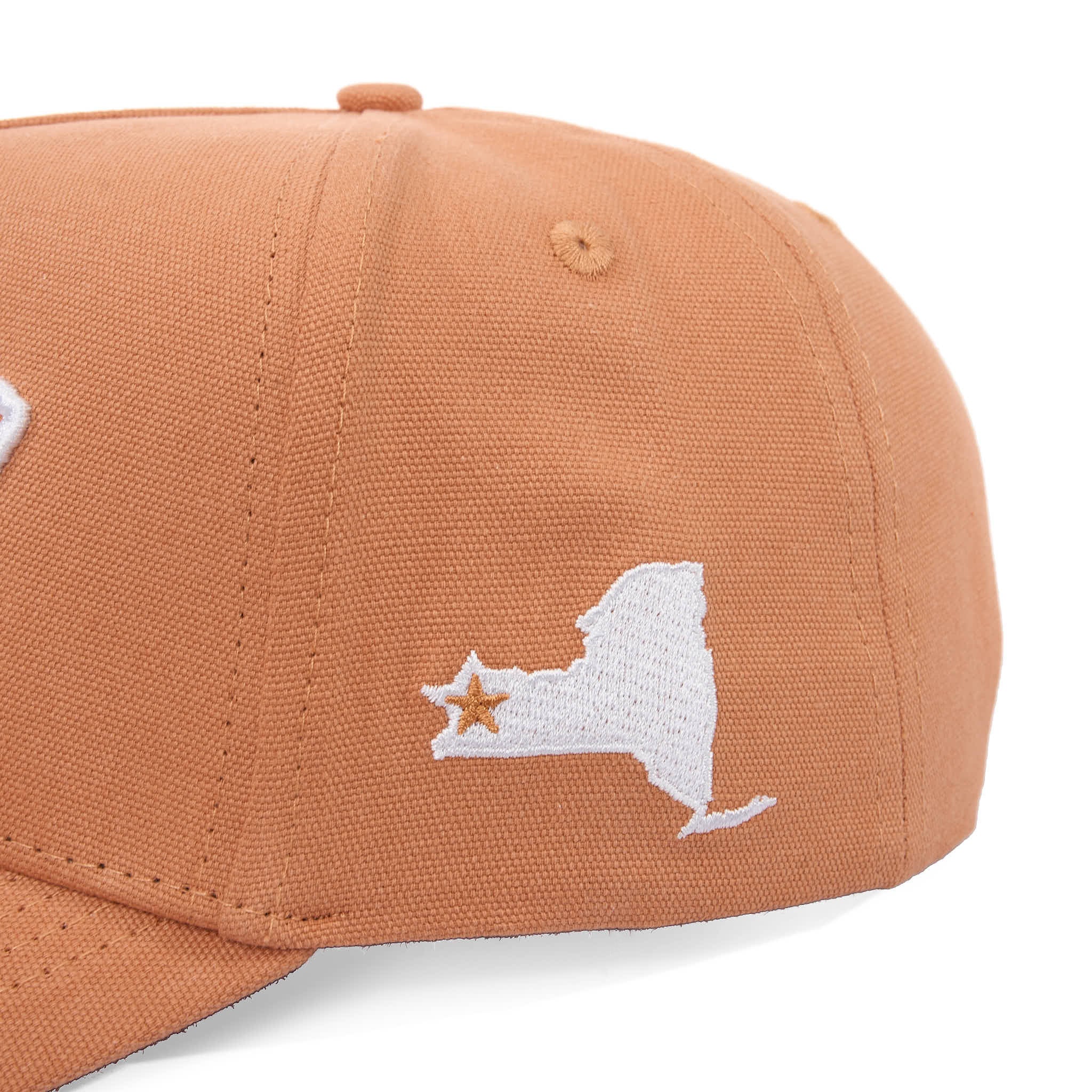 Brown cap with white embroidered design on a white background
