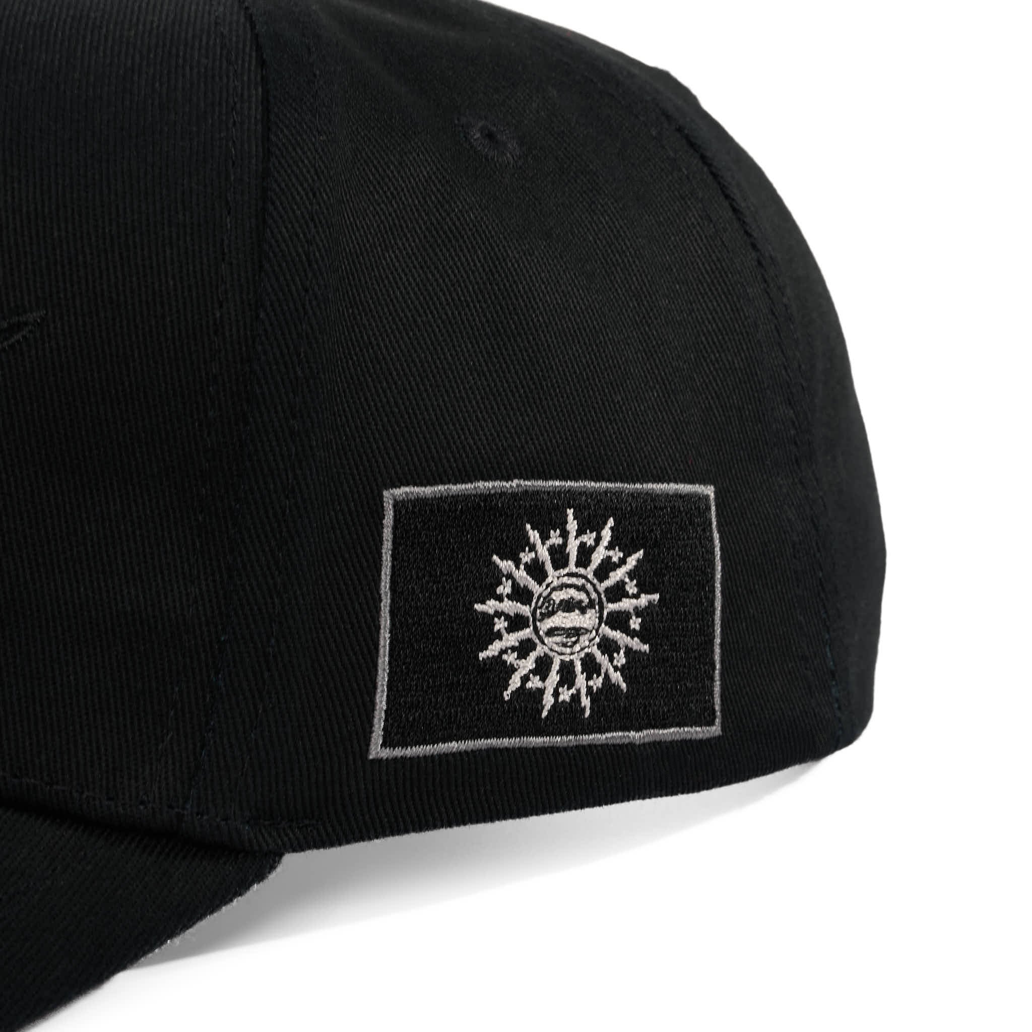 Black cap with a white embroidered flag on a white background