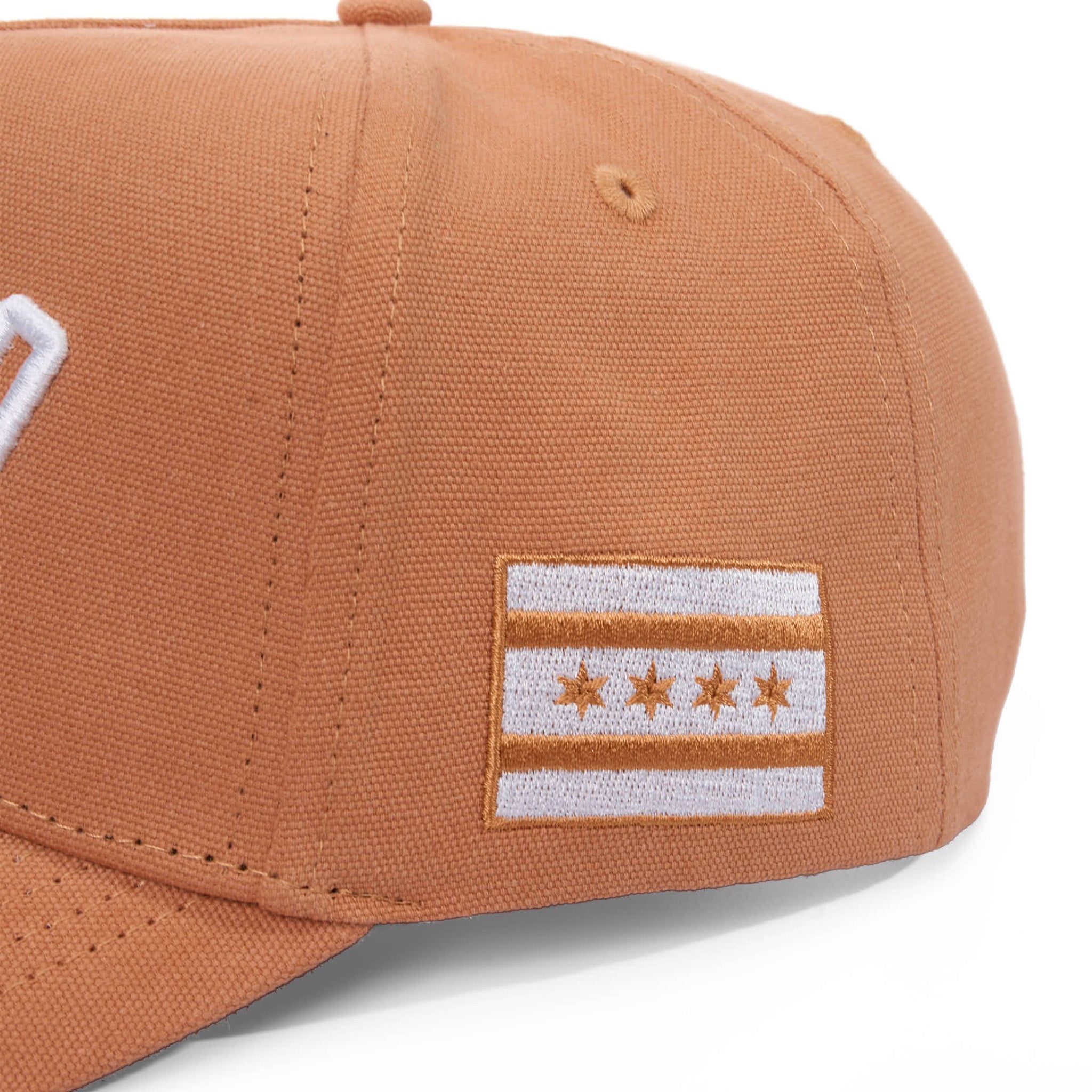 Brown cap with a flag patch on a white background