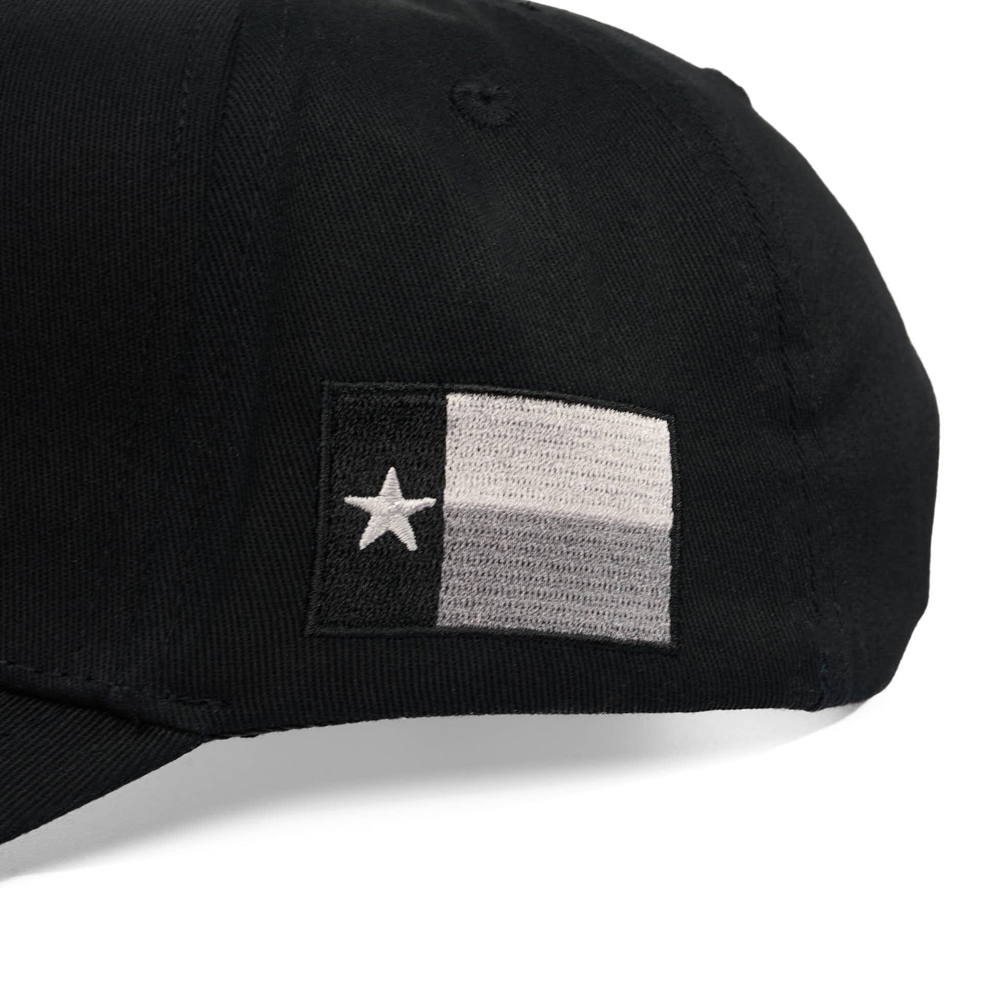 Black cap with a flag patch featuring a white star on a gray background