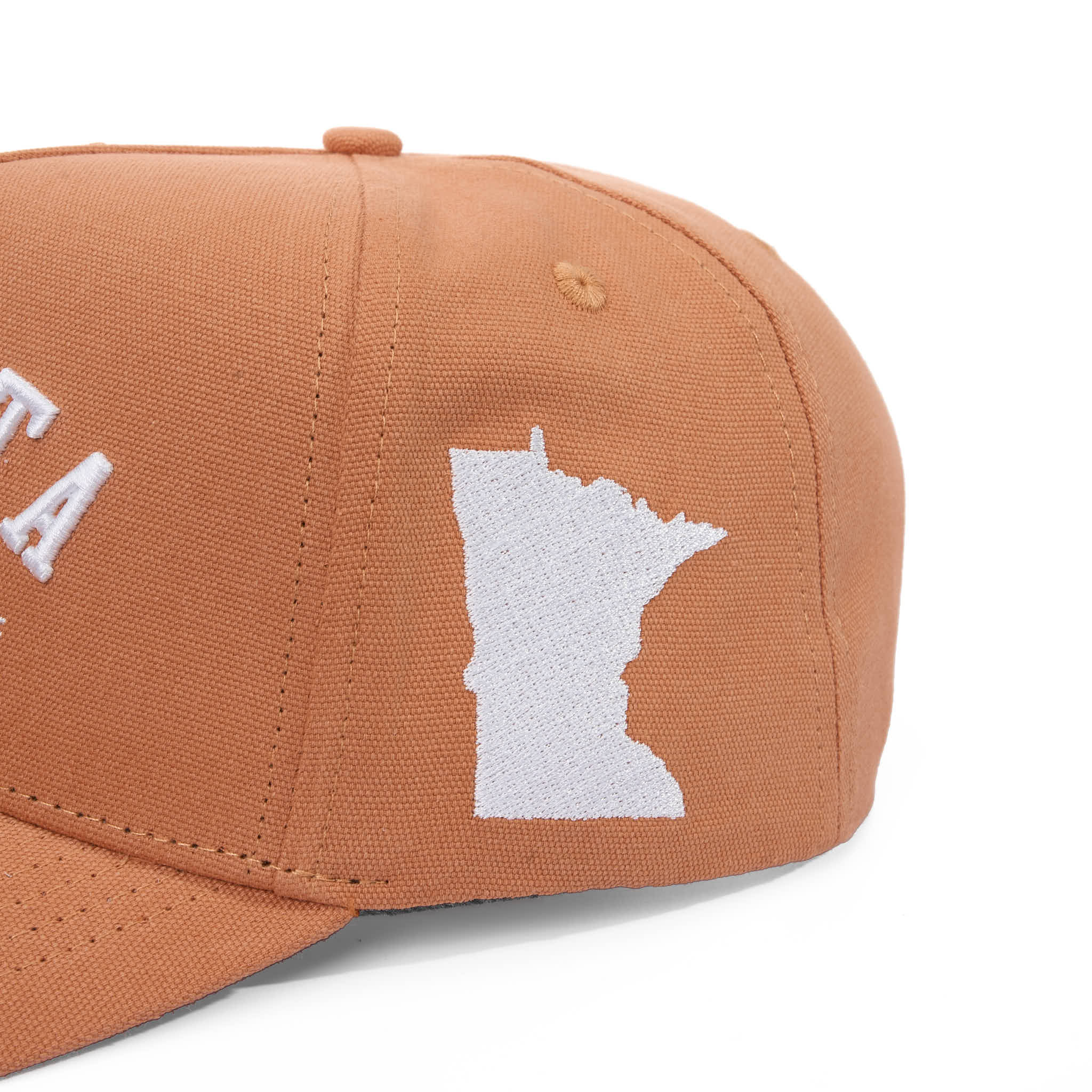 Brown cap with white embroidered design on a white background