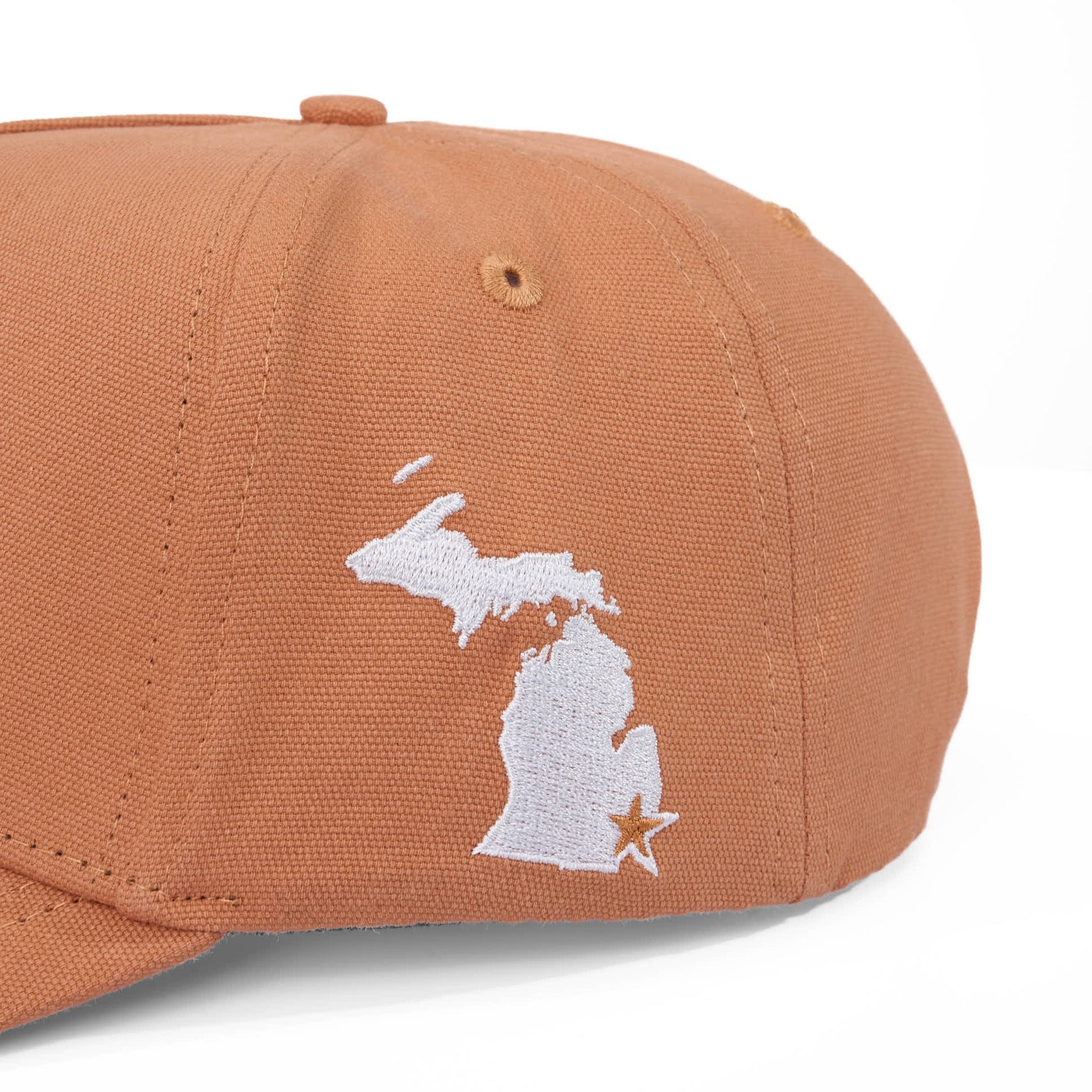 Brown cap with white outline of a state and star on a white background