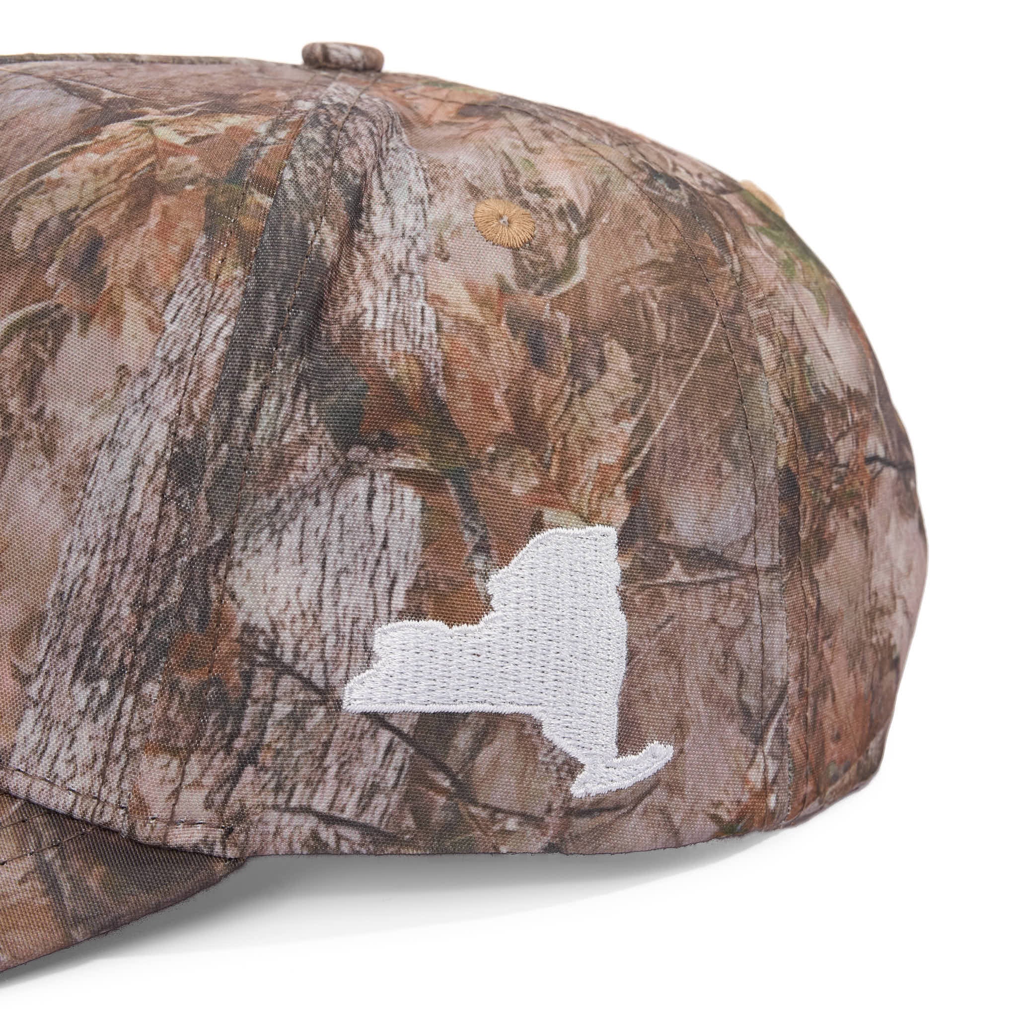 Camouflage baseball cap with a white logo on a white background