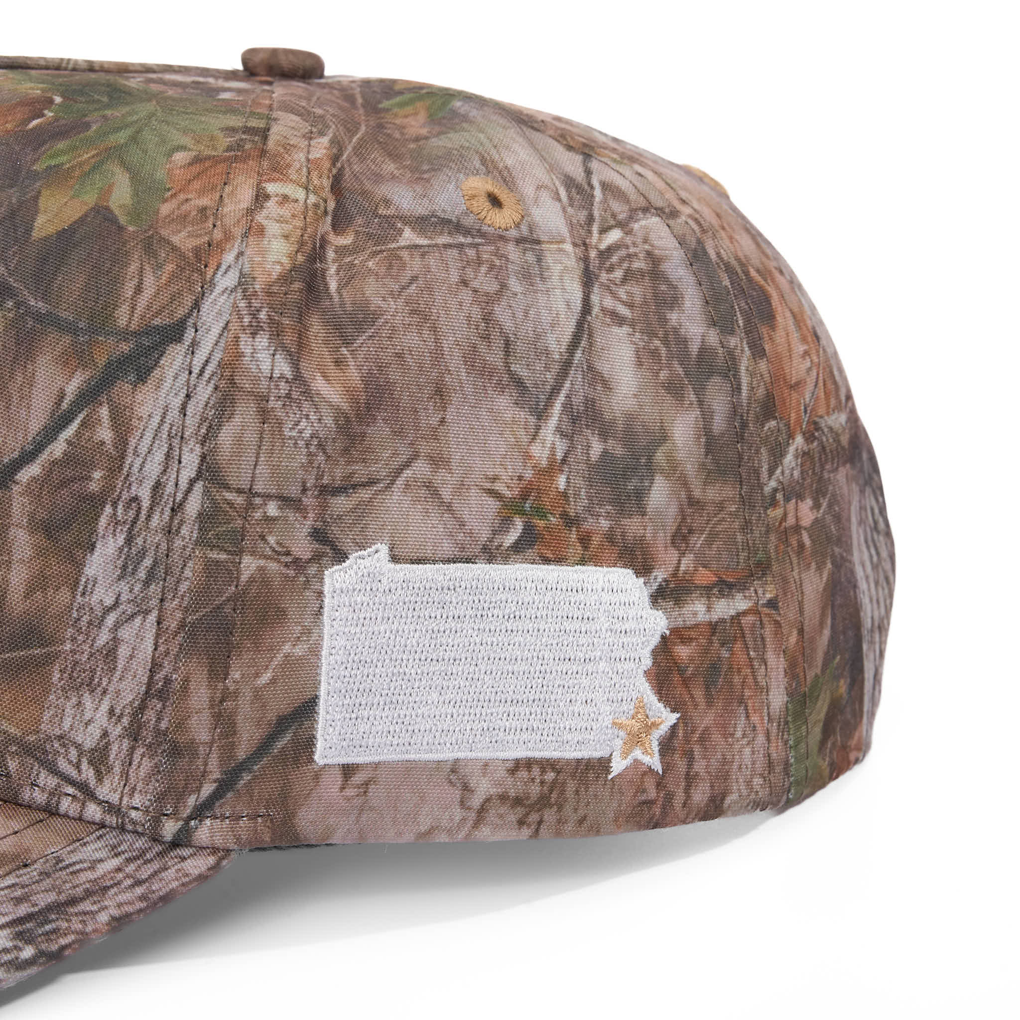 Camouflage baseball cap with a state outline on a white background