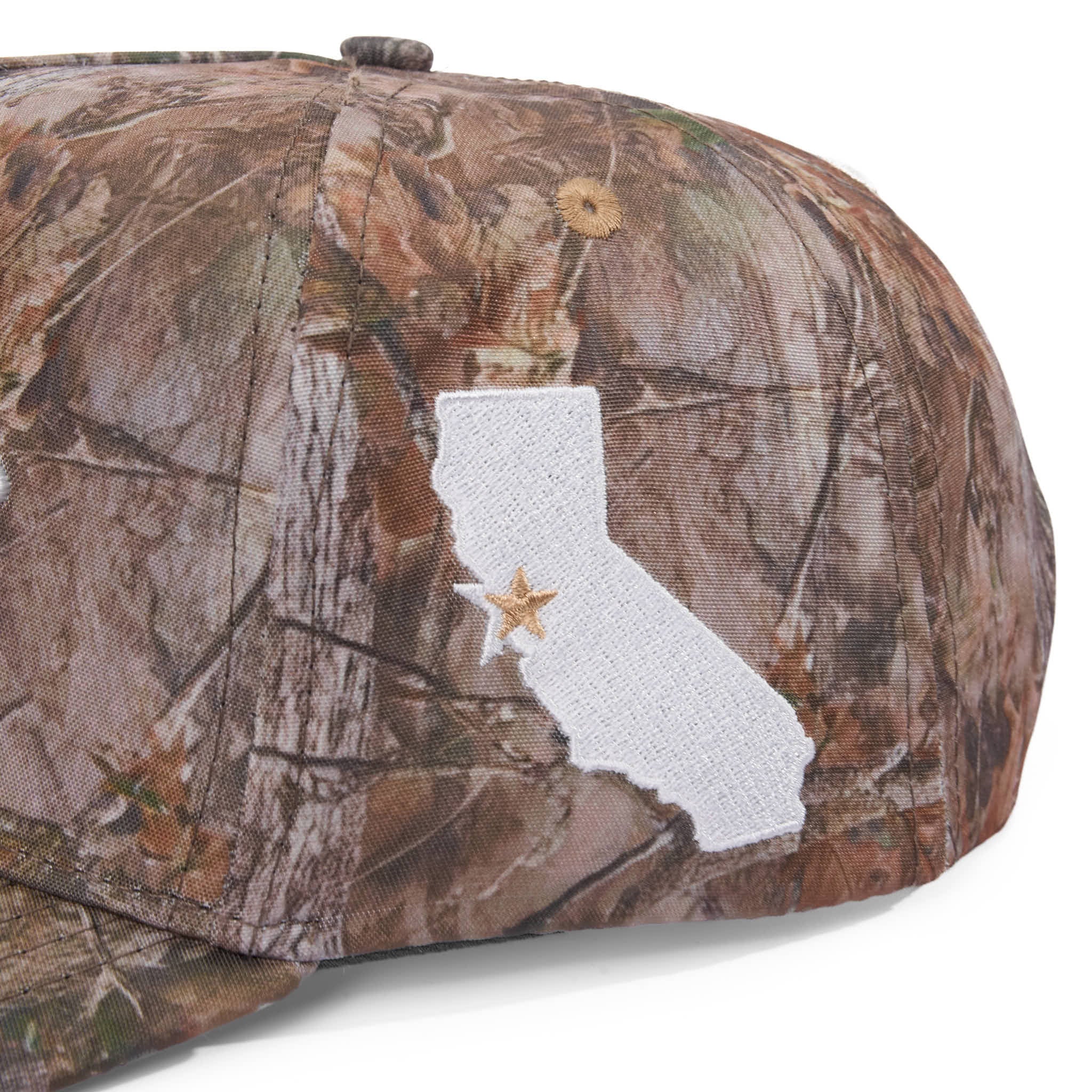 Camouflage cap with a white outline of California and a star on a white background
