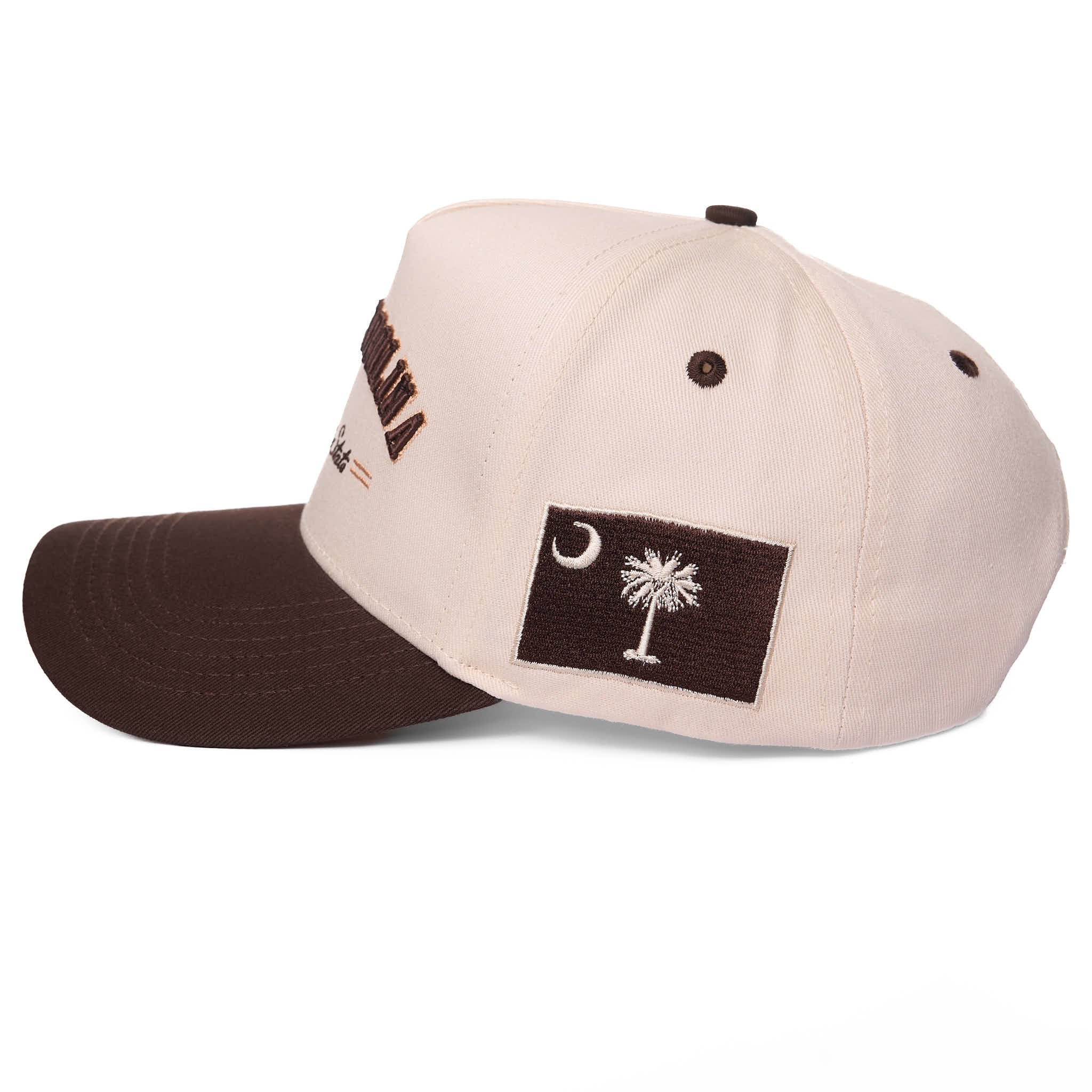 Beige and brown cap with a flag patch on a white background