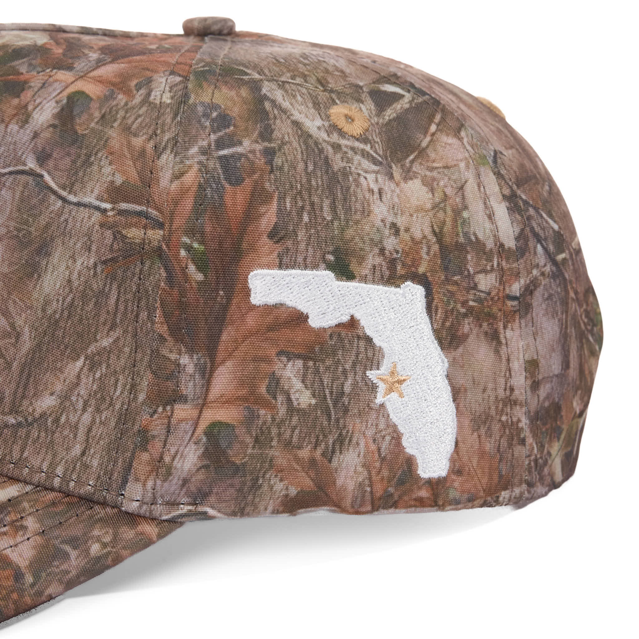 Camouflage cap with a white patch featuring a star design on a white background