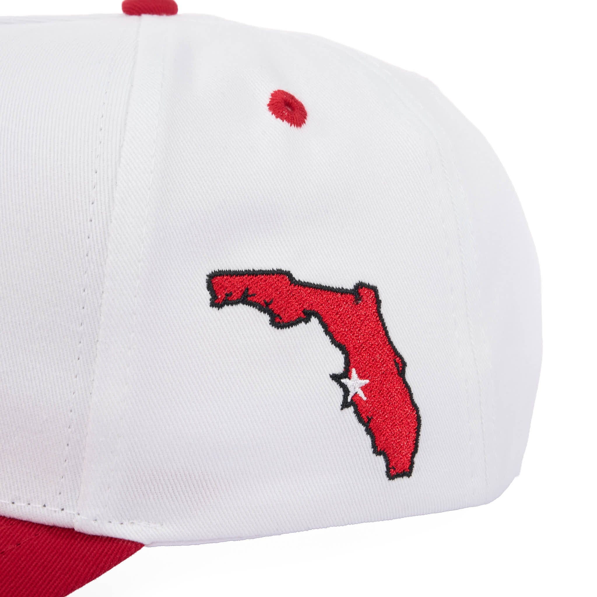 White cap with red map of Florida and white star design on a white background
