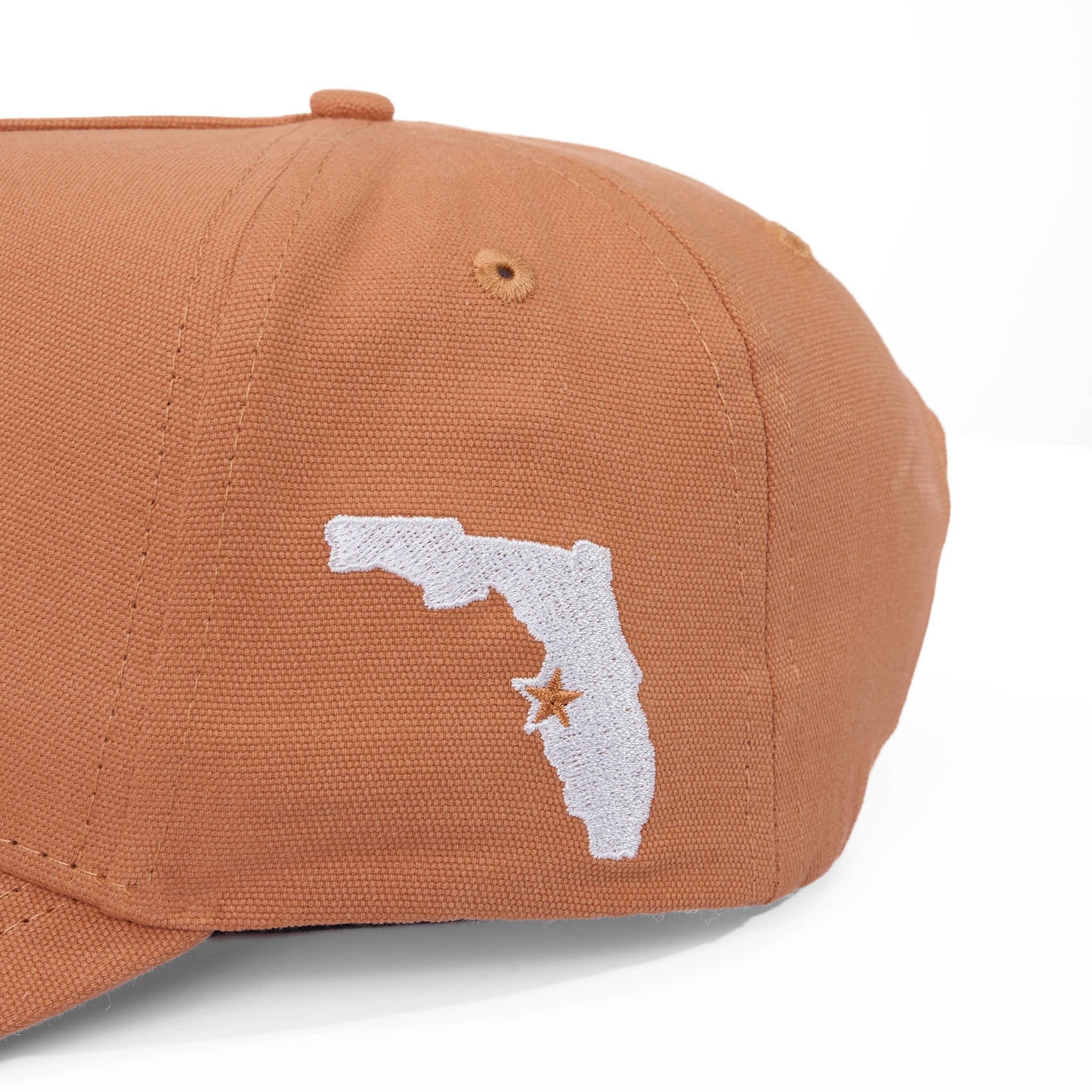 Mesa cap with white outline of Florida and star on a white background