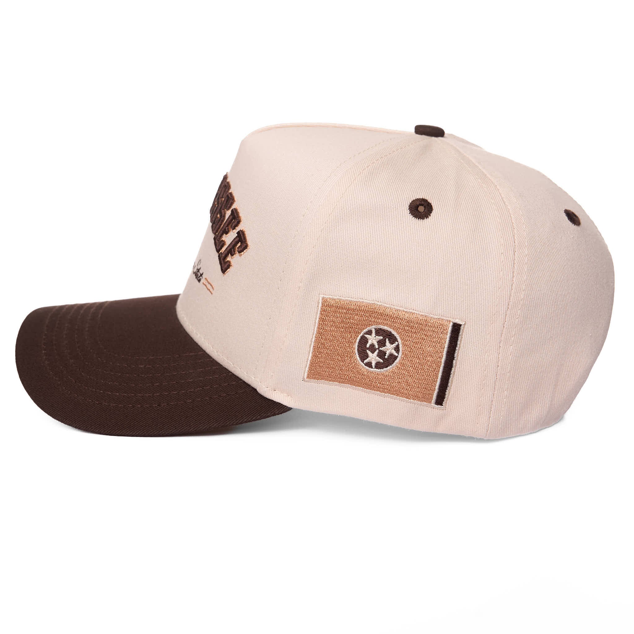 Two-tone cap with brown visor and beige bill featuring a logo on a white background