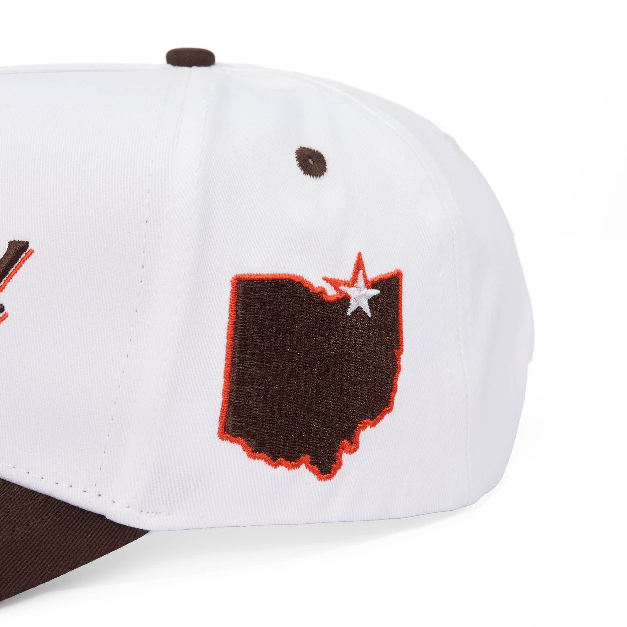 White cap with brown and orange design on a white background