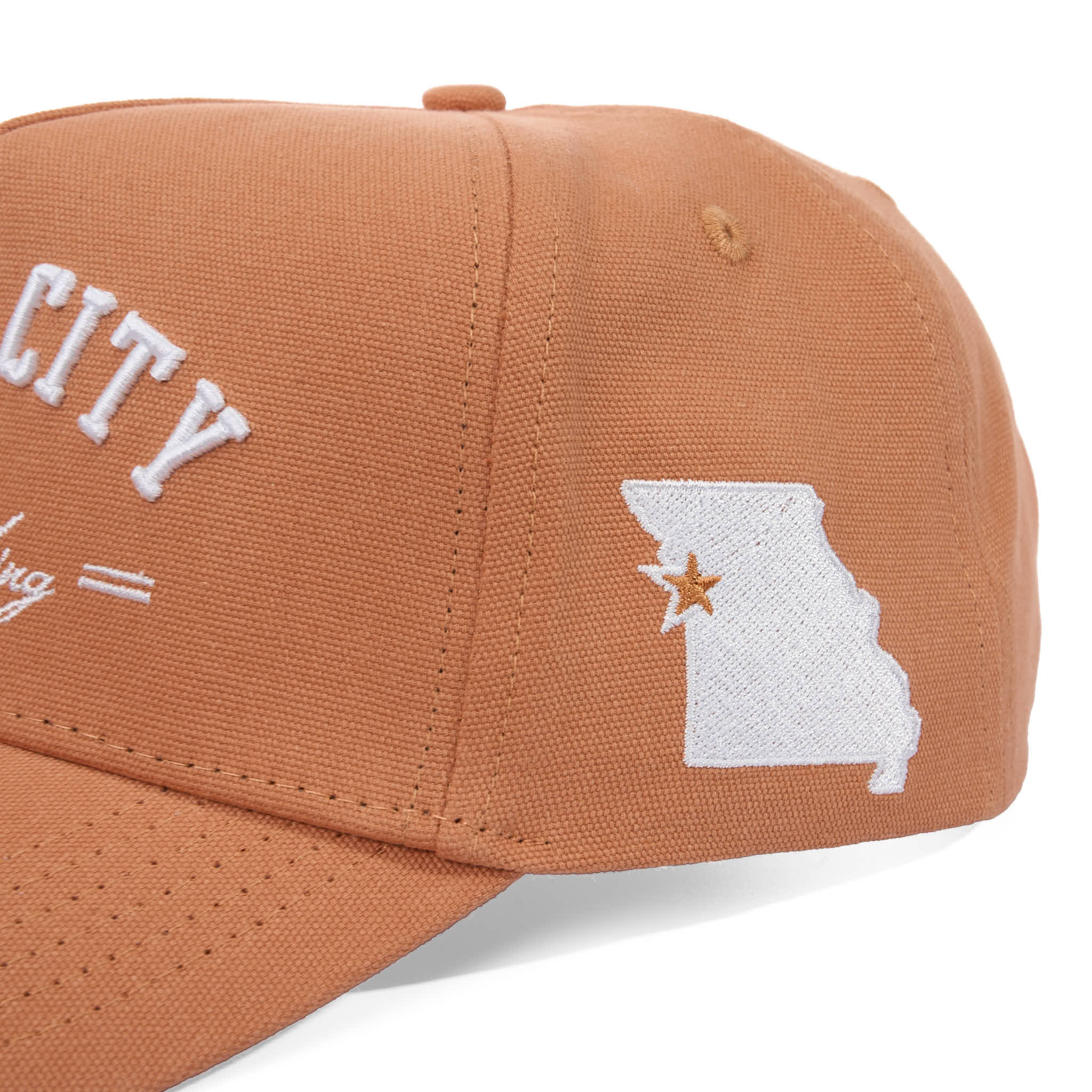 Brown cap with 'CITY' text and Missouri state outline embroidered on a white background