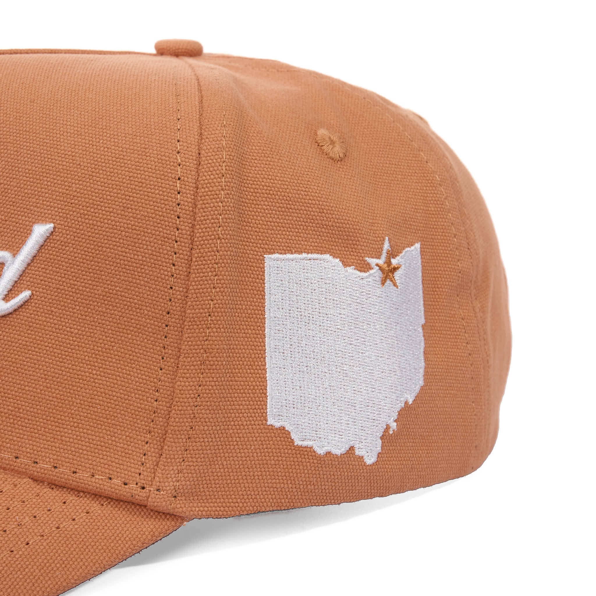 Brown cap with white embroidered design on a white background