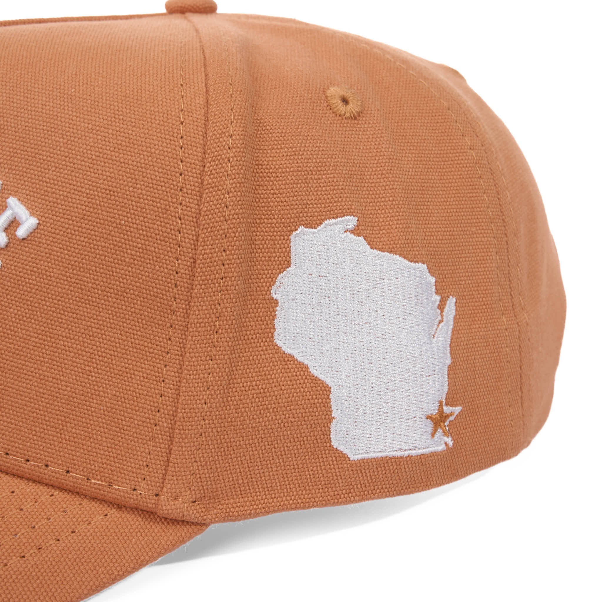 Brown cap with white embroidered design on a white background