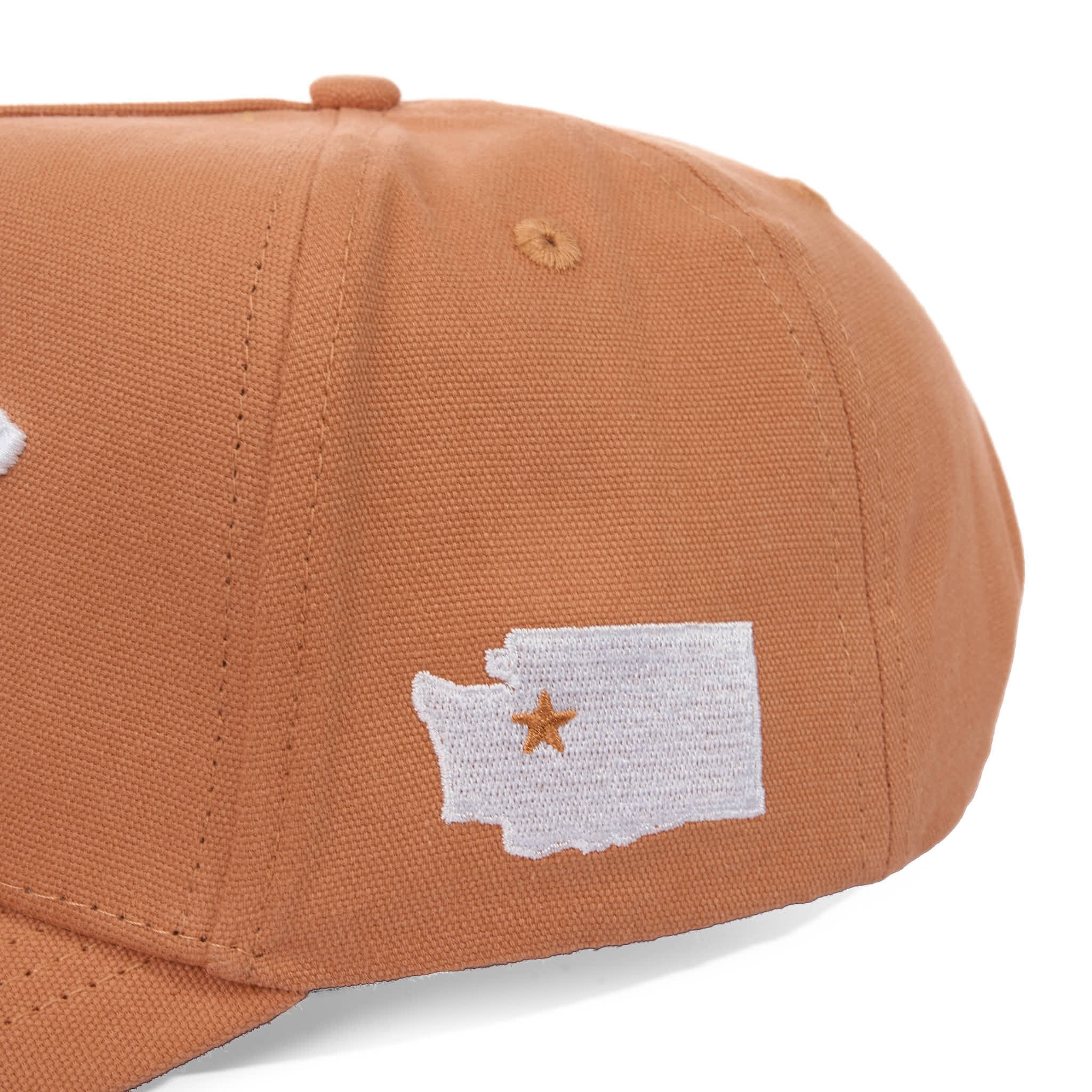 Brown cap with a white patch featuring a star and outline of a state on a white background