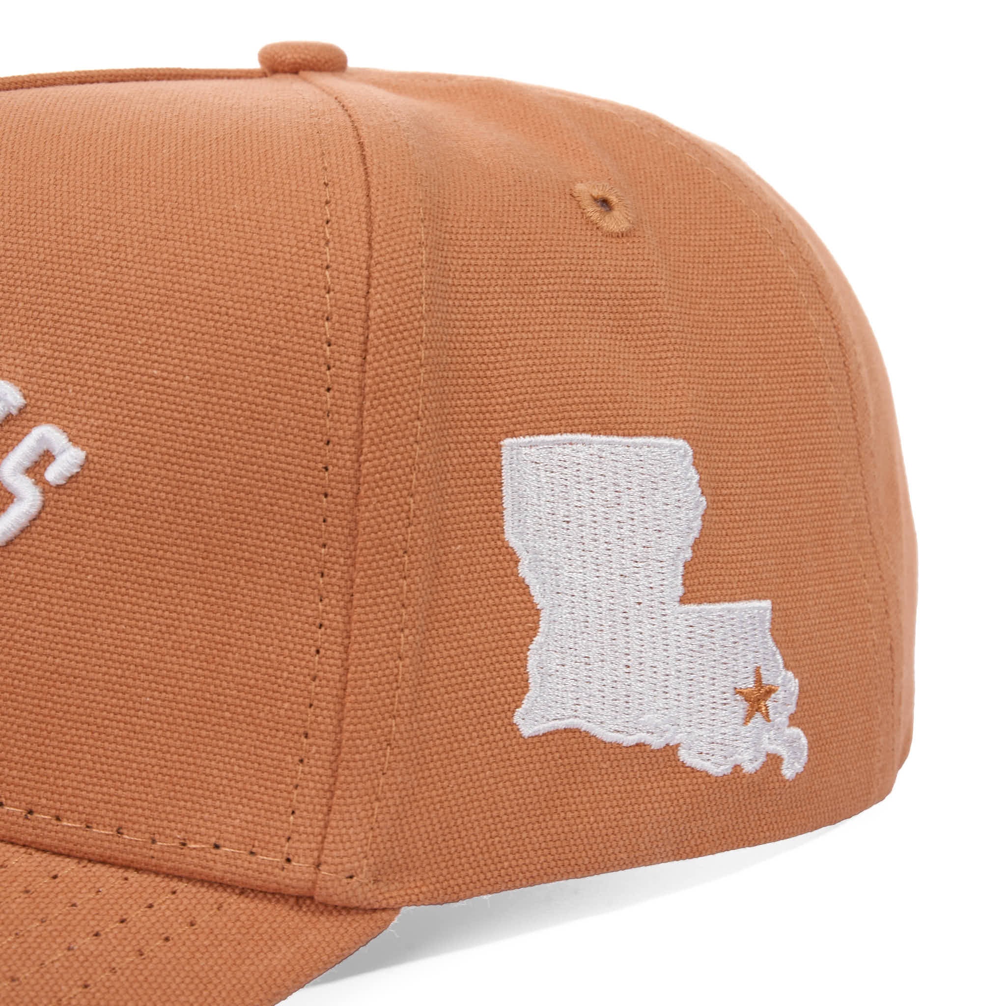 Brown cap with white embroidered design of a state map and star on a white background