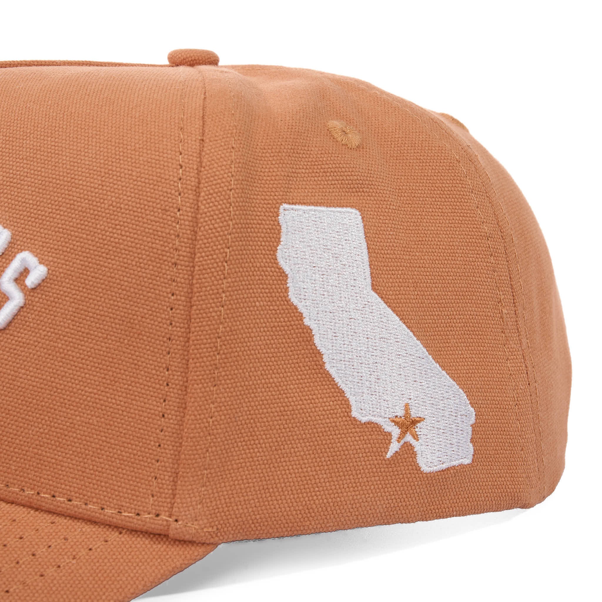 Brown cap with white embroidered design of a state and star on a white background