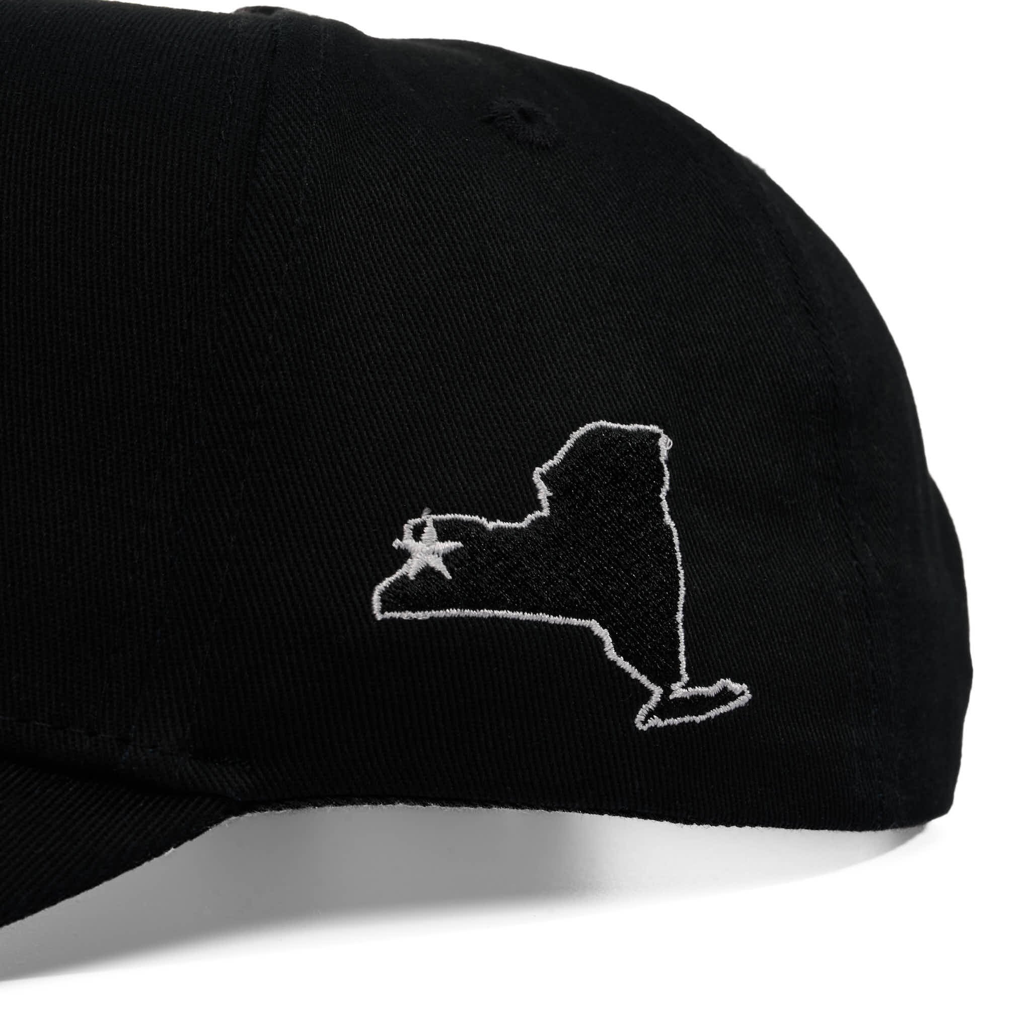 Black cap with white embroidered design on a white background