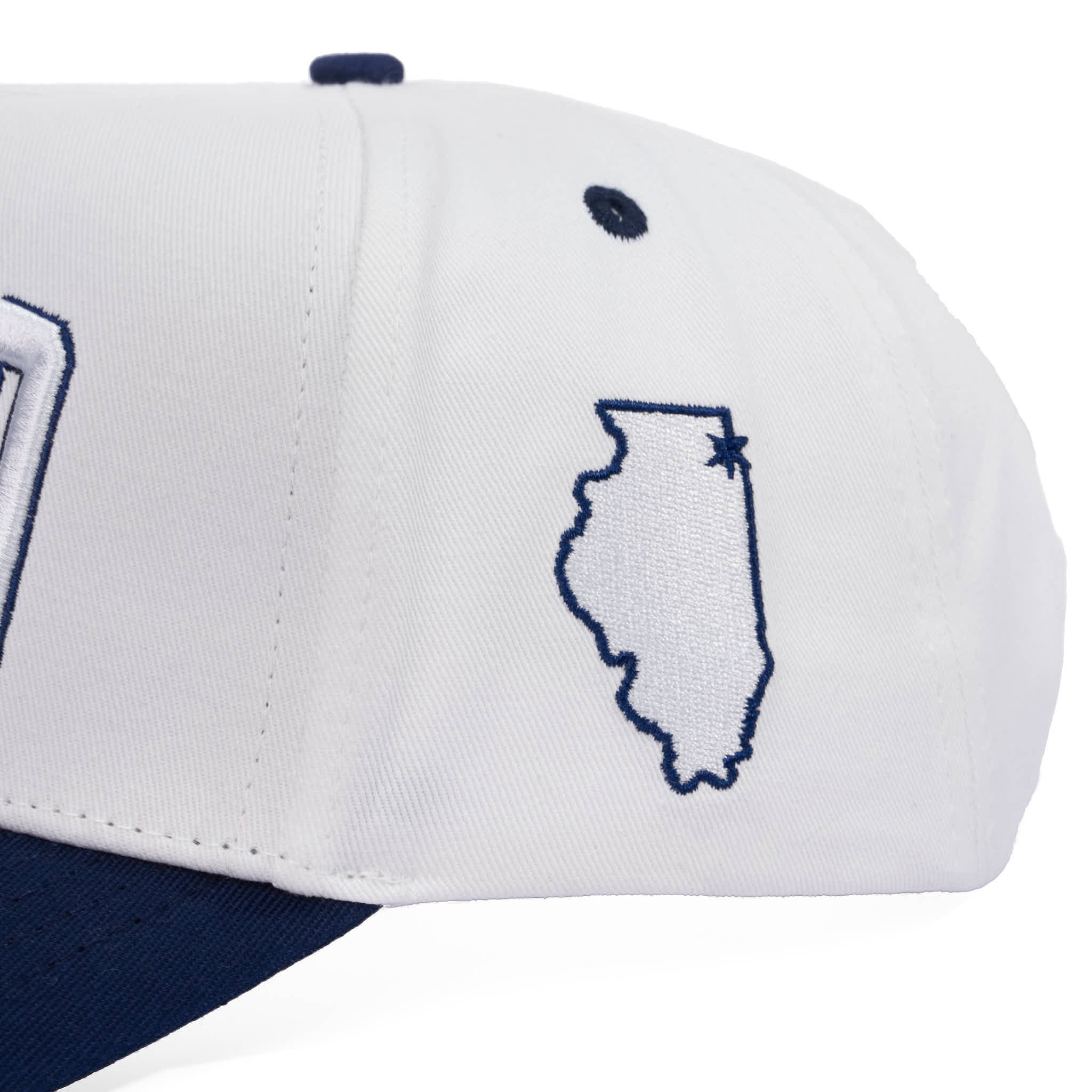 White and navy cap with Illinois outline embroidery on a white background