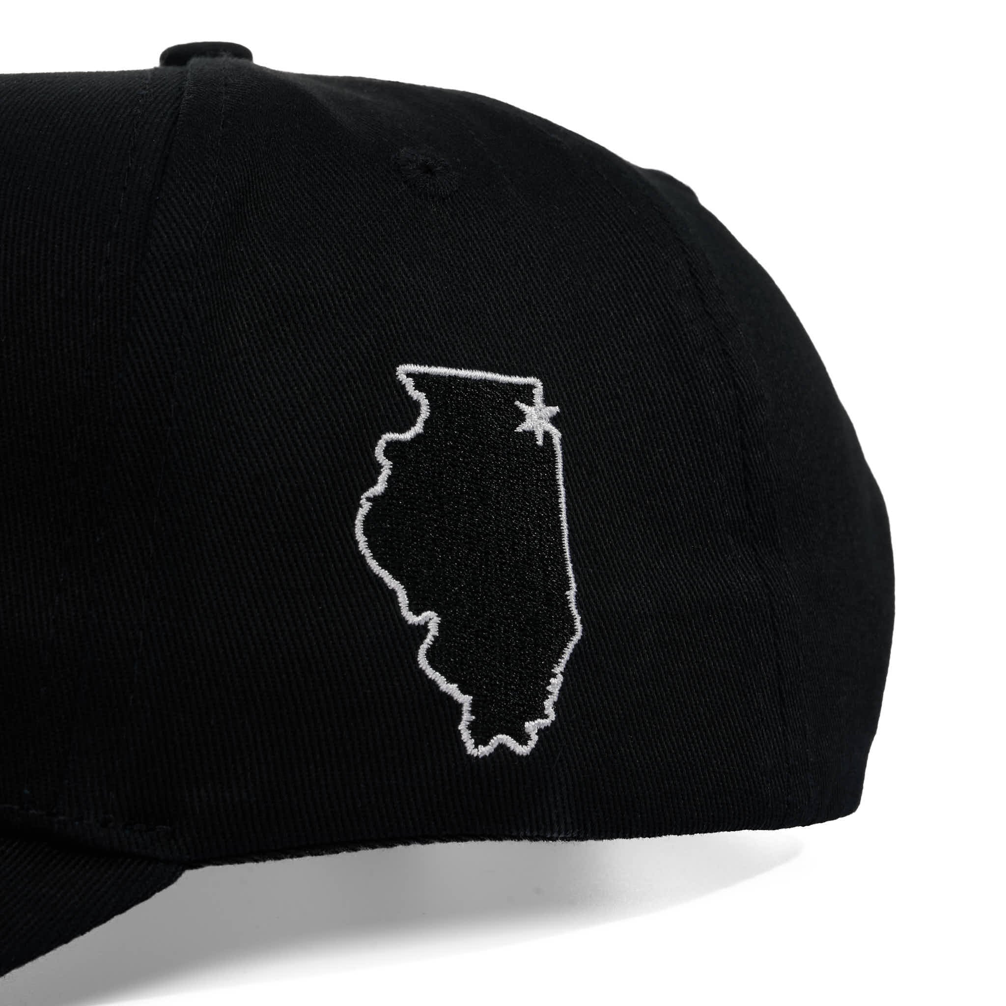 Black cap with white outline of Illinois and star on a white background