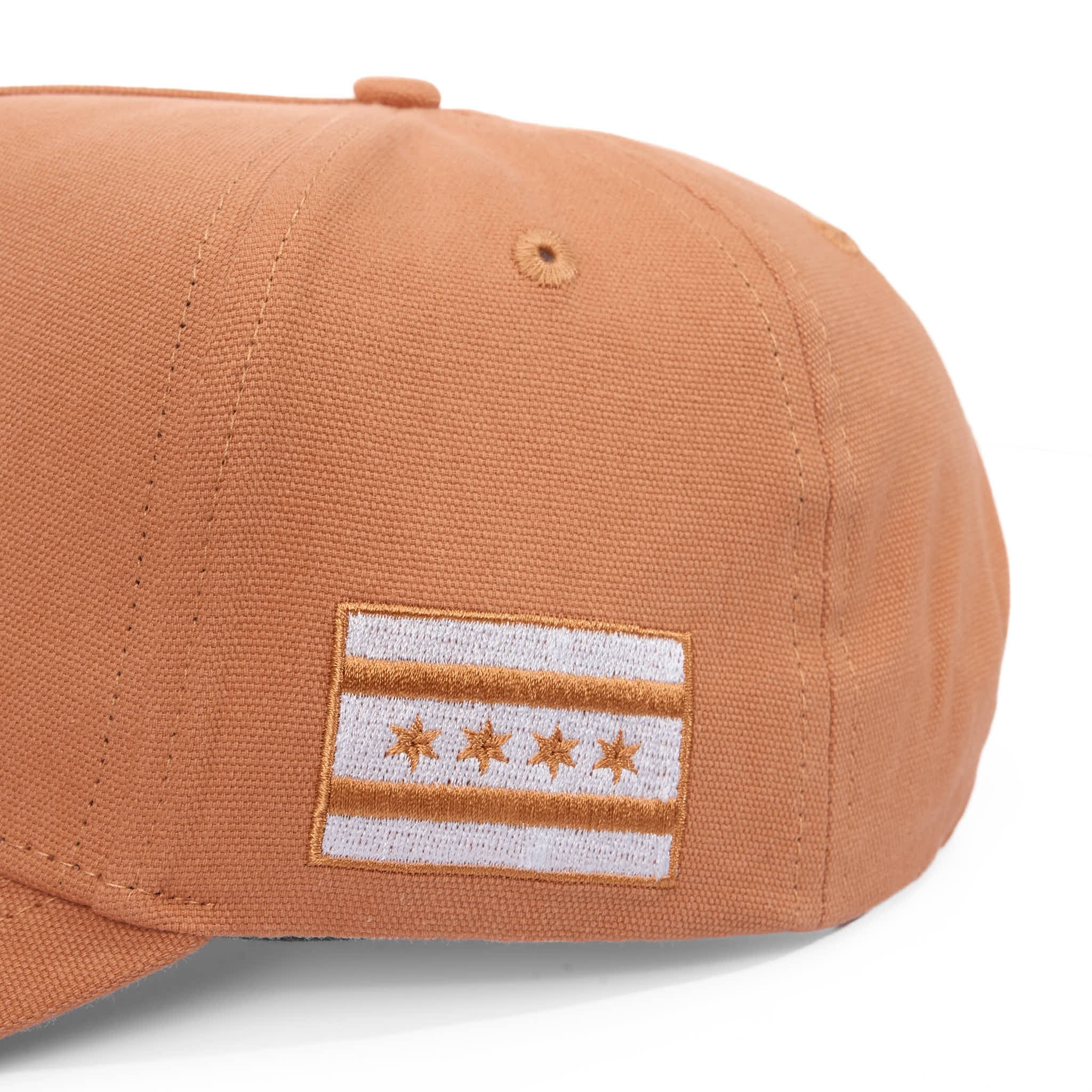 Brown cap with a flag patch on a white background