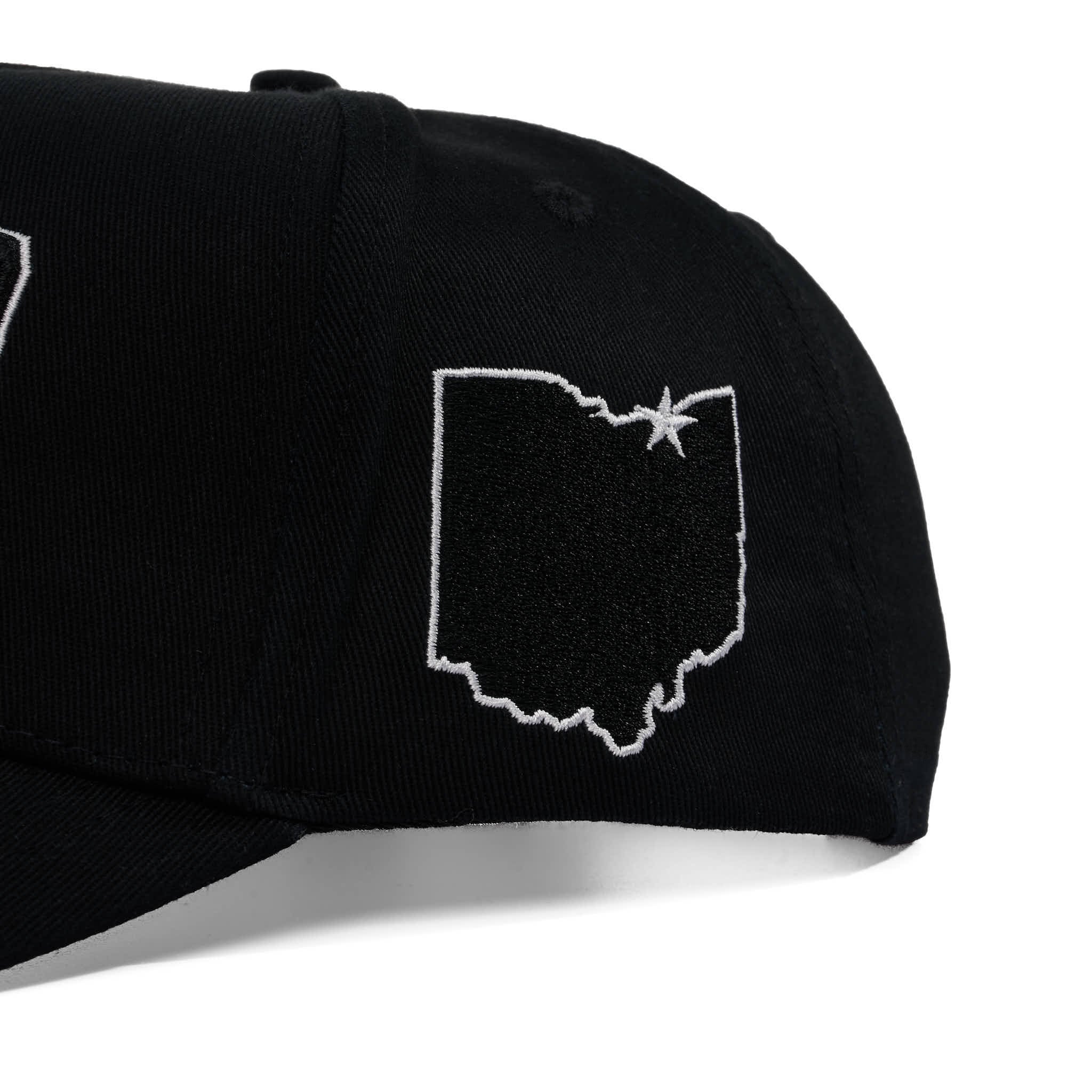 Black cap with white outline of Ohio and star on a white background