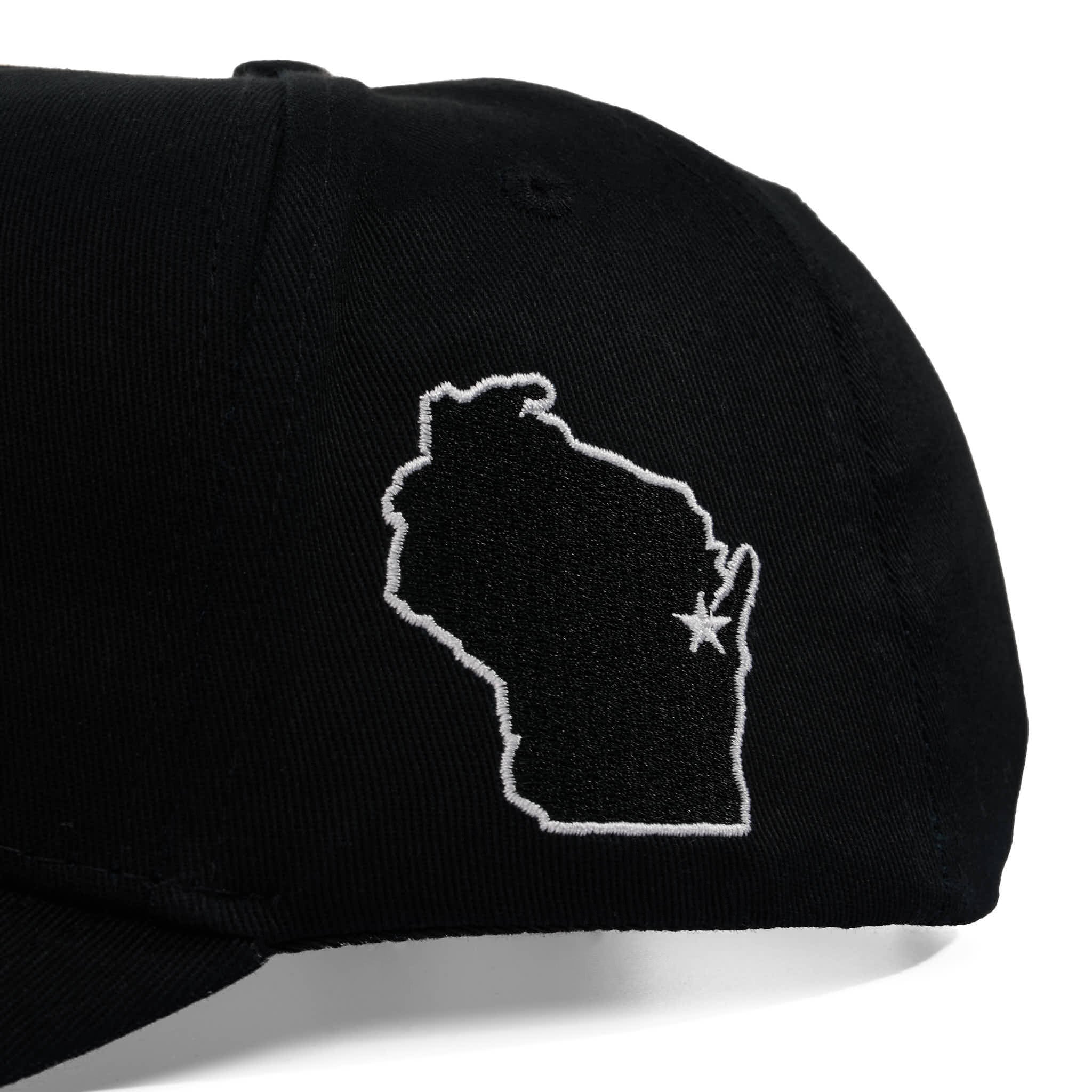 Black cap with white outline of Wisconsin and star on a white background