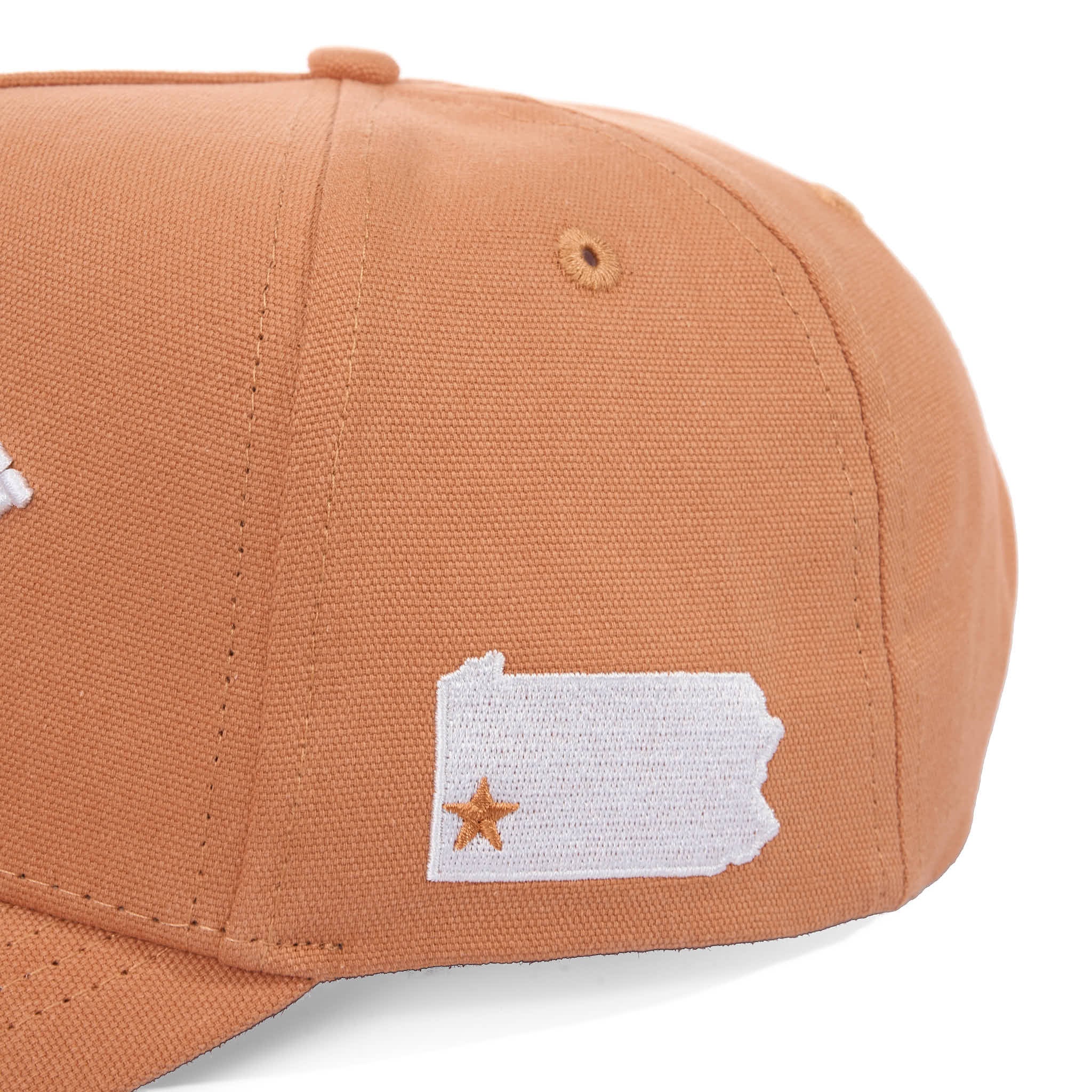 Brown cap with a white patch featuring a star design on a white background