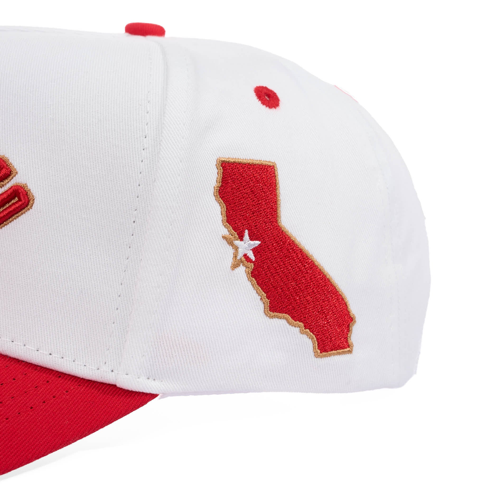 White and red cap with a red outline of California and a white star on a white background